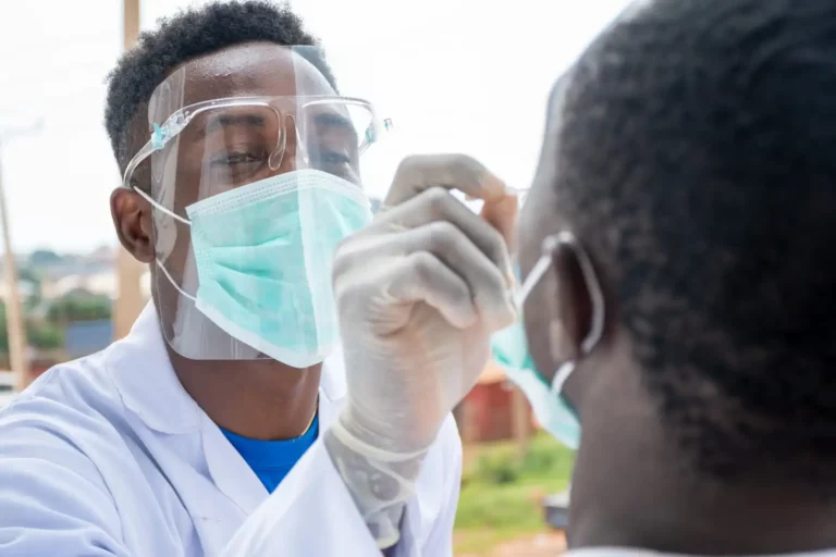 Doctor Taking Sample Of Patient With Possible Viral Infection